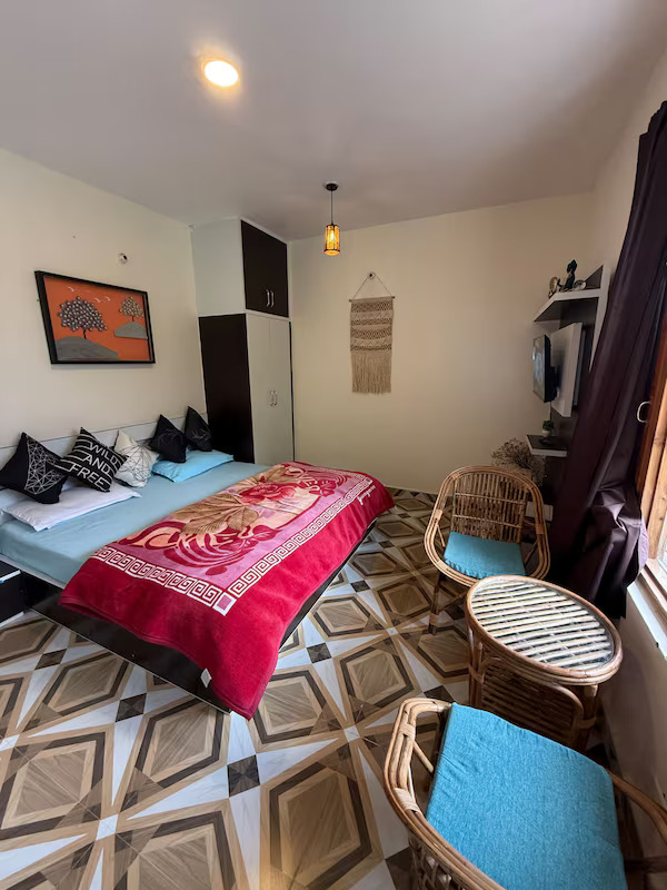 Bonfire and outdoor seating at Tarang Stays with mountain views